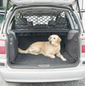 Dog in car boot behind a black mesh barrier net